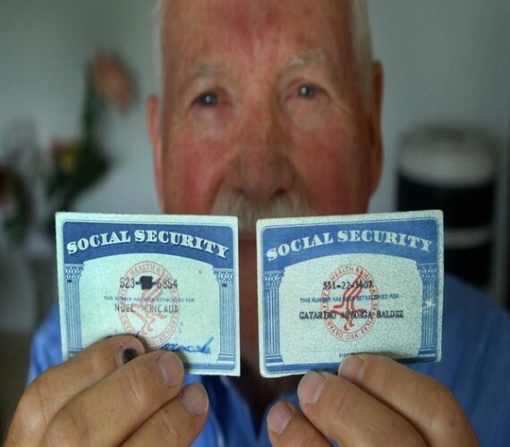 Former INS employee Charlie McClure shows two social security cards, one real and one fake. McClure used to train employers on what to look for on the social security card and green cards that could tip them off that the document might be fake. (The one on the left is real, and the one on the right is fake.)  (Photo By Kathryn Osler/The Denver Post via Getty Images)