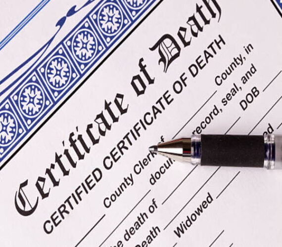 Death Certificate with pen. Close-up of top of certificate with pen laying across page. Image shot with Canon 5D Mark2, 100 ISO, 24-115mm lens, studio strobes.